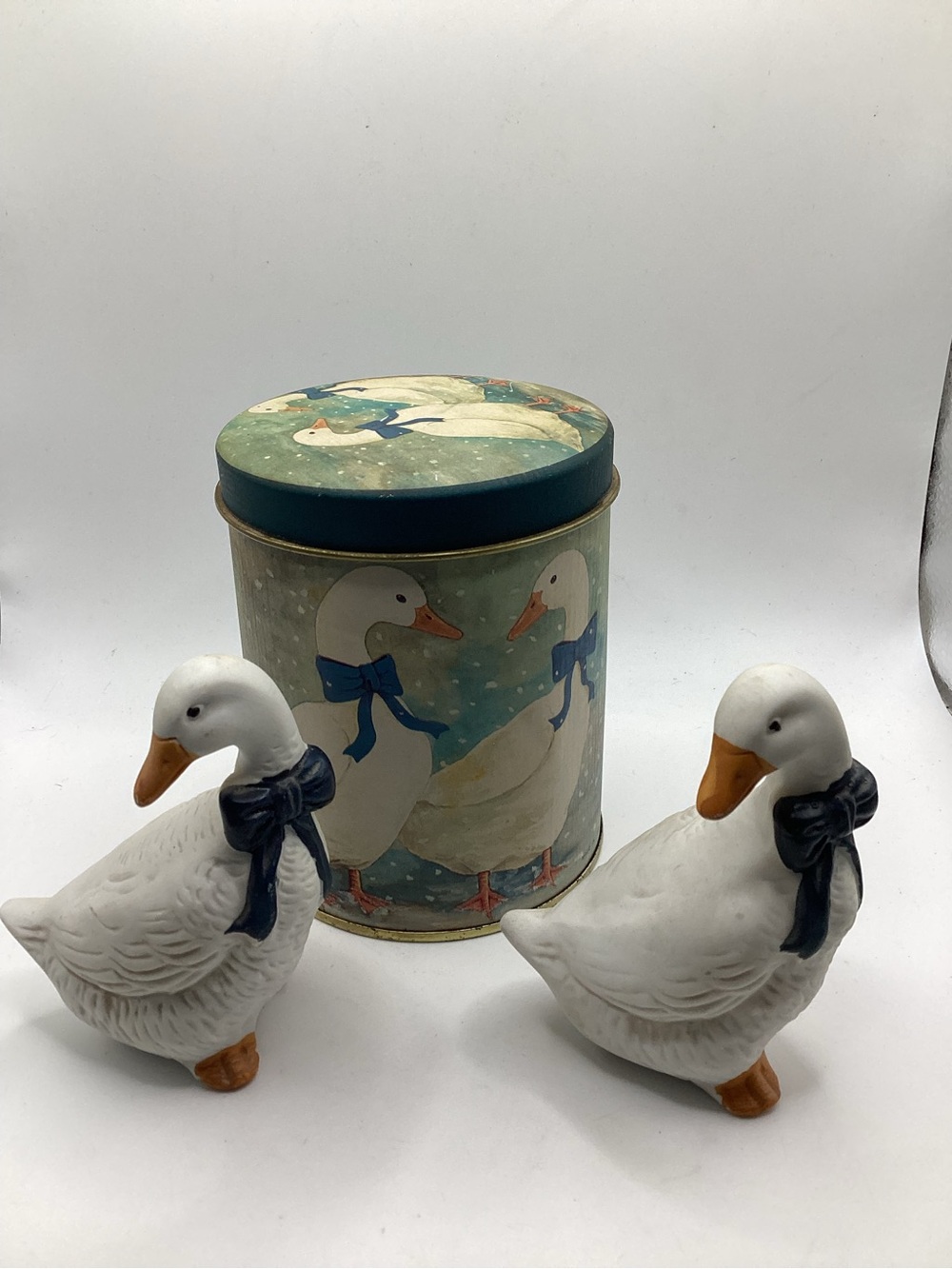 Decorative White Goose Figurines with Blue Bow and Matching Tin
